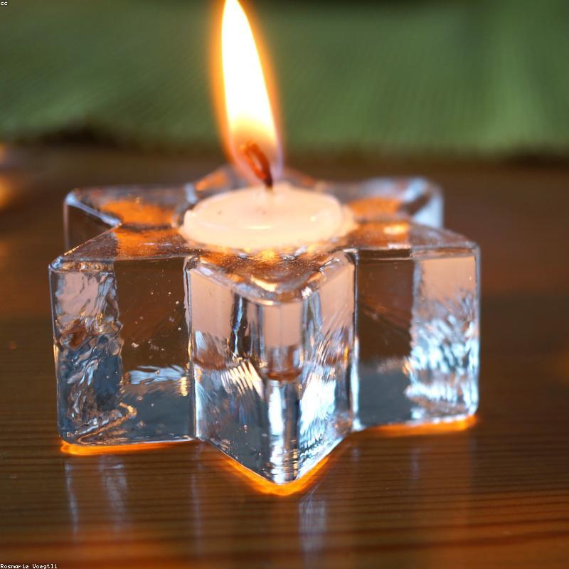 A hand-poured Neura Candle glowing warmly